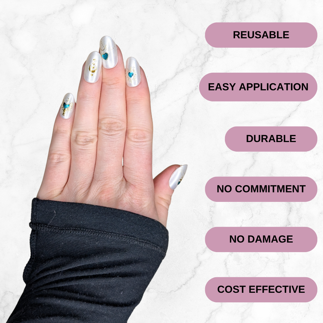 Image of a left hand wearing Snap Nails in Signature collection of 5 oval pearl nails gold details on a marble background. Reusable, easy application, durable, no commitment, no damage and cost effective.
