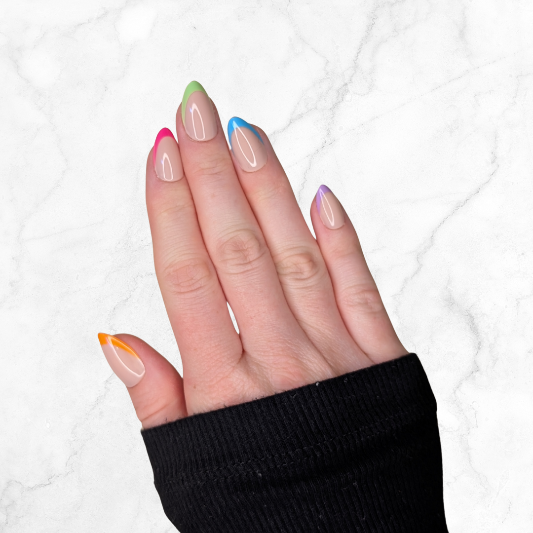 Right hand showing almond french tipped nails each with a different colour on a marble background.