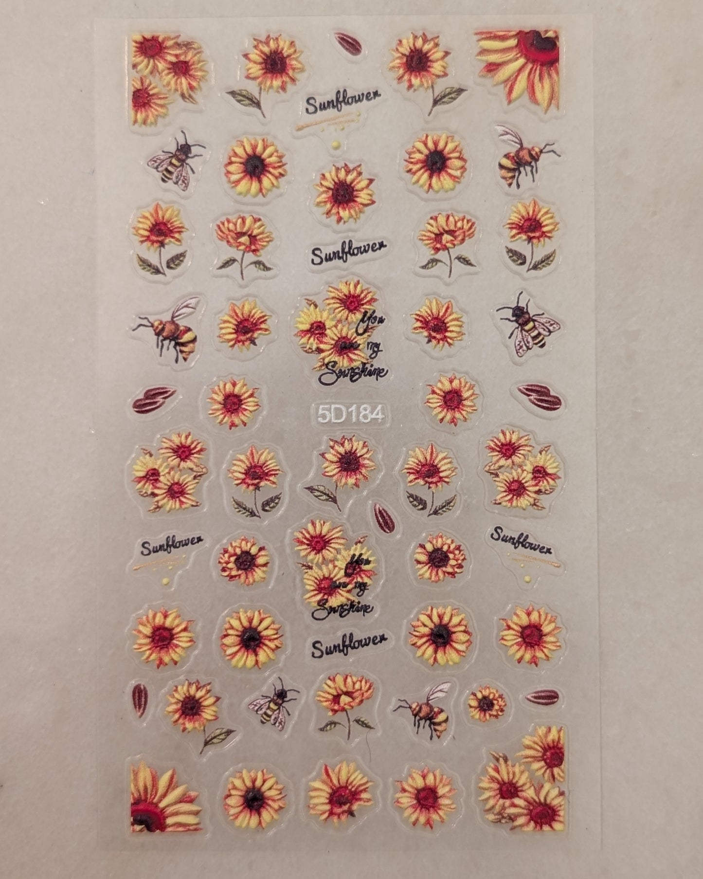 Varying sizes of sunflowers, some with multiple heads and bees.