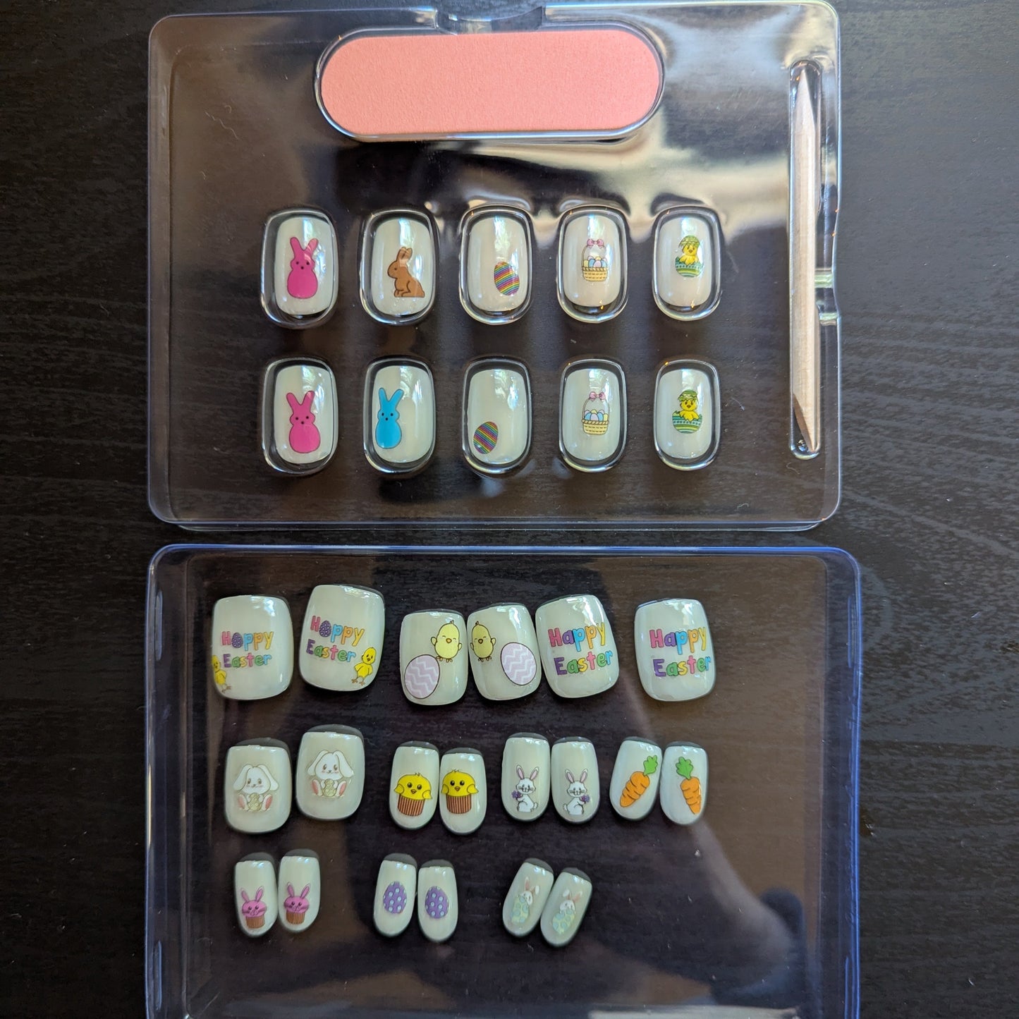 Image of a Snap Nails box with 10 square pearl press on gel nails with various Easter designs, a nail file and cuticle stick.
Underneath this is a clear box with 20 square pearl press on gel nails with various Easter designs.