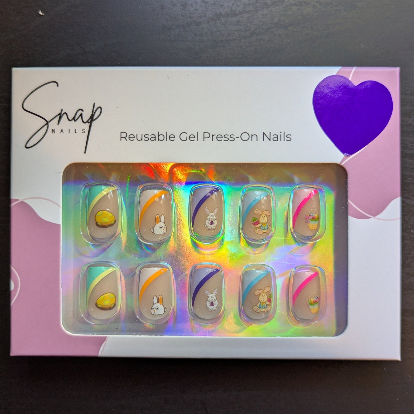 Image of a Snap Nails box with 10 square press on gel nails with various tip colours and Easter designs.