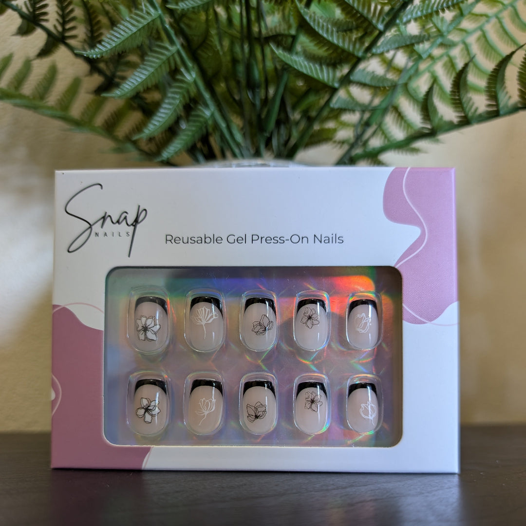 Image of box of Snap Nails in Signature collection of 10 square black french tip nails with black and white fine black and white details.