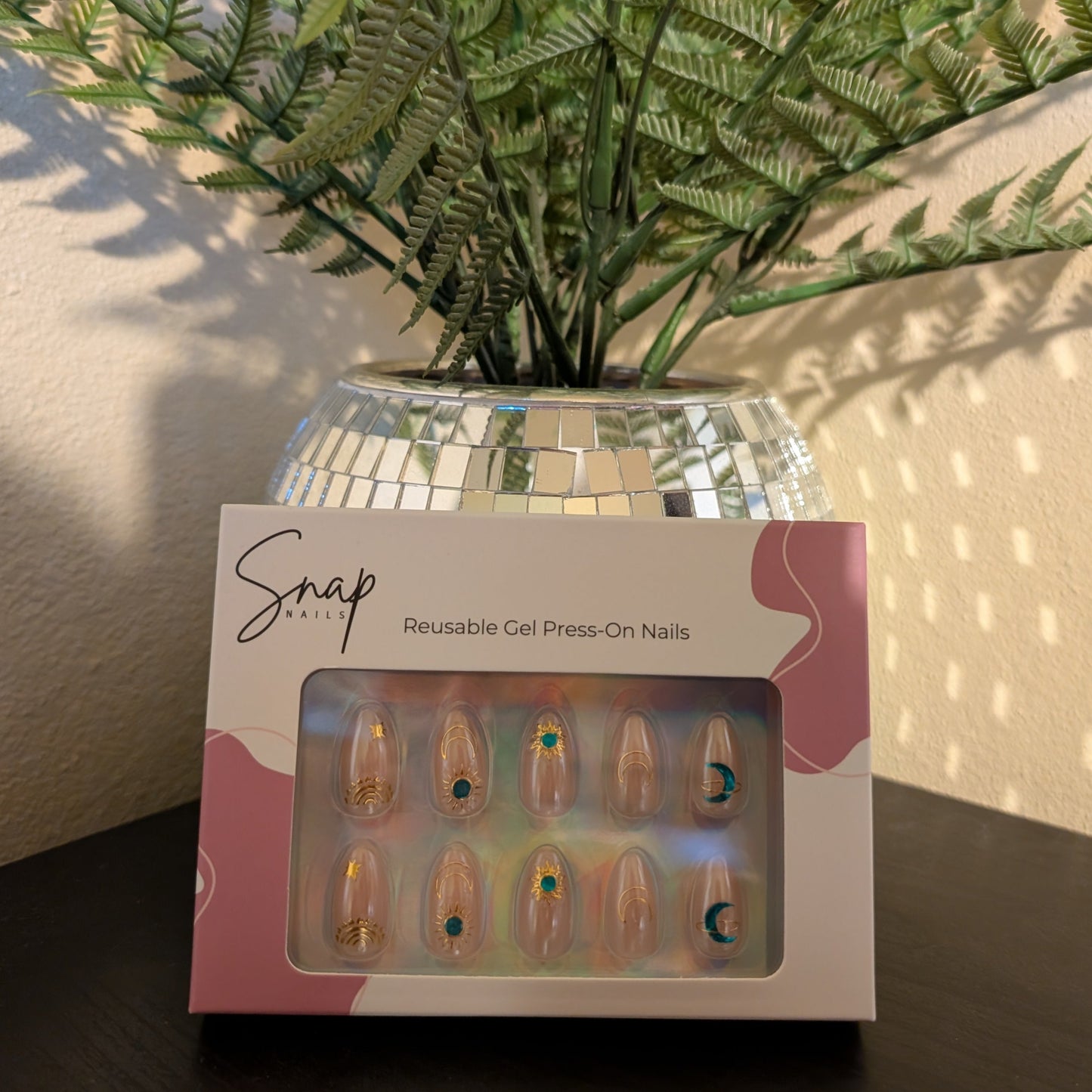 Image of box of Snap Nails in Signature collection of 10 almond peachy, shimmery nails with gold details.