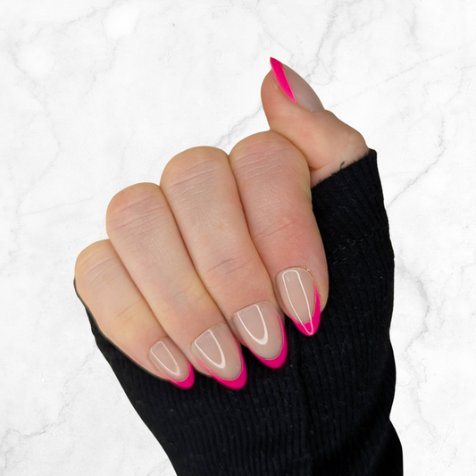 right hand showing hot pink tipped almond french nails on a marble background.