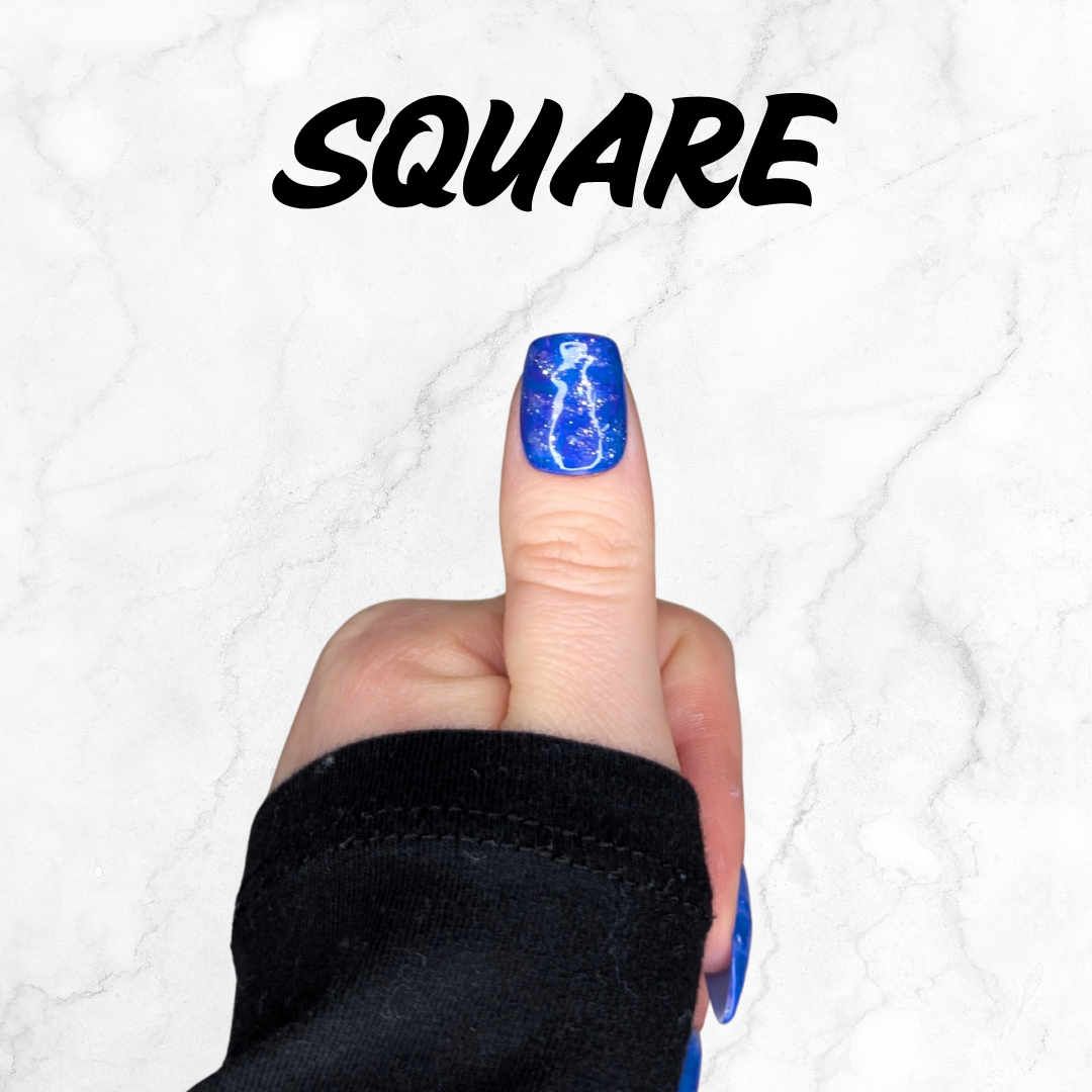 Finger wearing blue and purple marbled press-on nails with silver sparkle in a square shape.