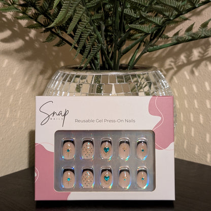 Image of box of Snap Nails in Signature collection of 10 square black french tip nails with gold details. 